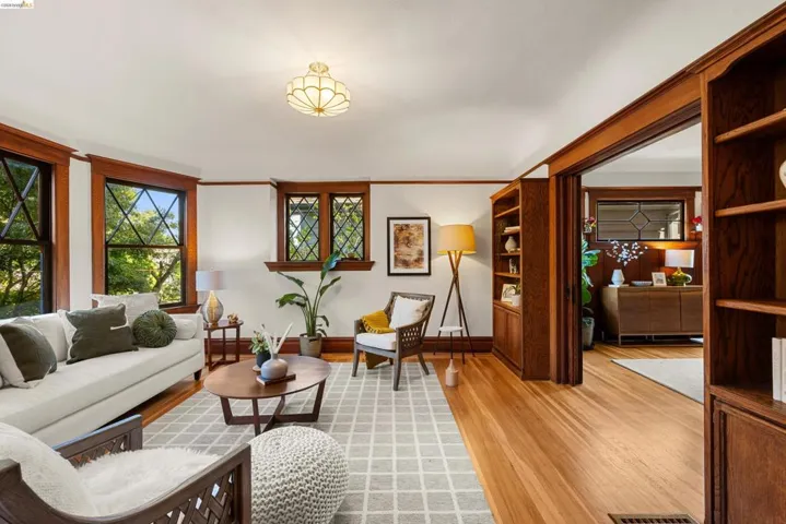Hardwood flooring throughout the room, featuring built-in shelving and an arched doorway
