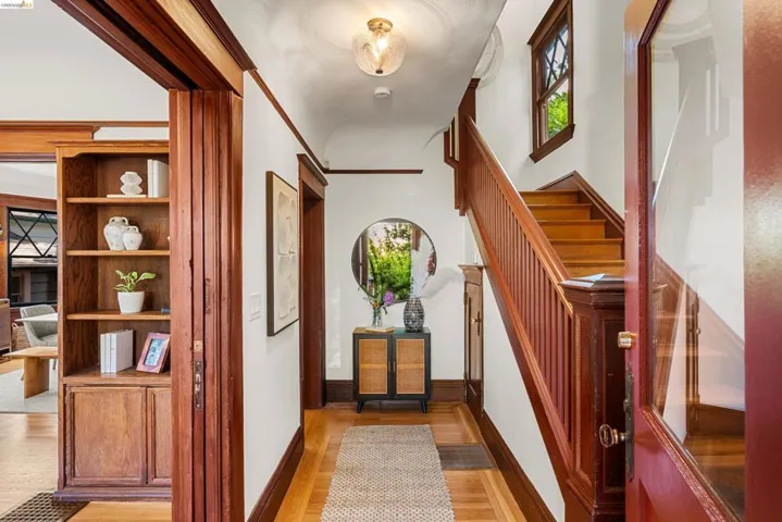 Entryway featuring rich wood trim and staircase with balusters