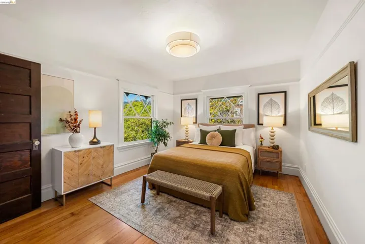 Bright room featuring hardwood flooring, white walls, and a recessed ceiling light fixture