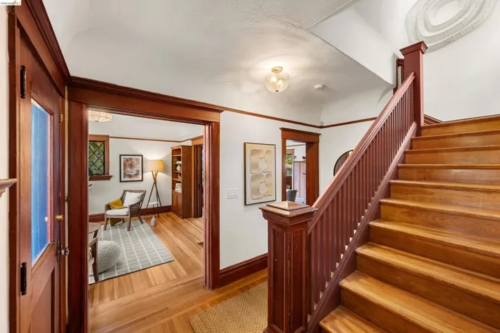 Grand staircase with rich wood finish and matching banister