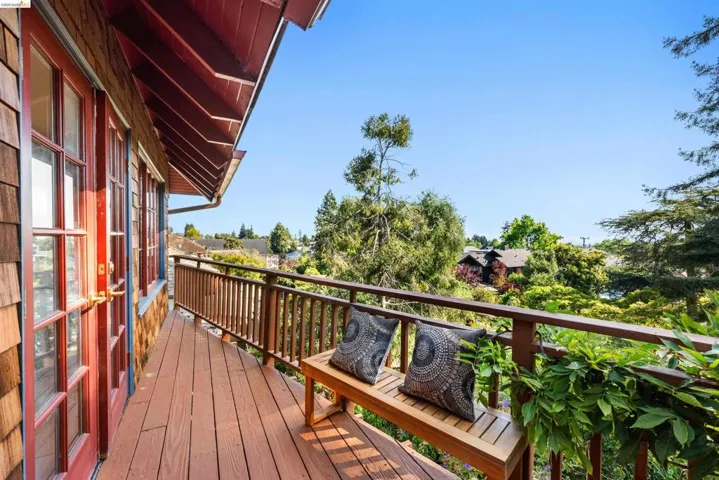Curved outdoor deck with a wood railing and natural wood plank flooring