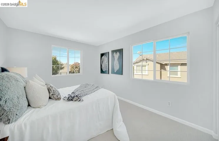 Wall-to-wall carpeting with light-colored walls and white baseboards