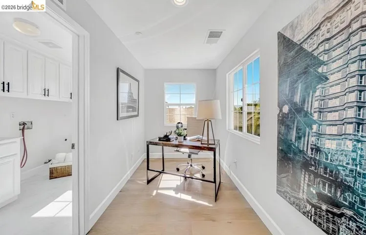 Bright room with wood-finish flooring, recessed lighting, and multiple windows
