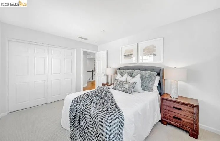 Neutral tone carpeting complements the light wall color
