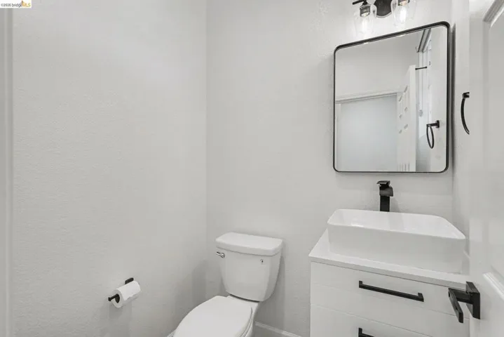 Modern bathroom featuring a rectangular vessel sink, matte black faucet, and coordinating hardware