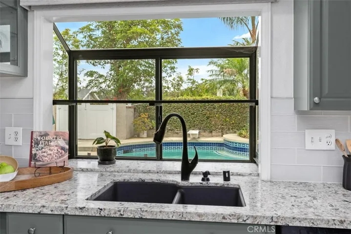 Enjoy the view of the gorgeous pool from the custom kitchen window.