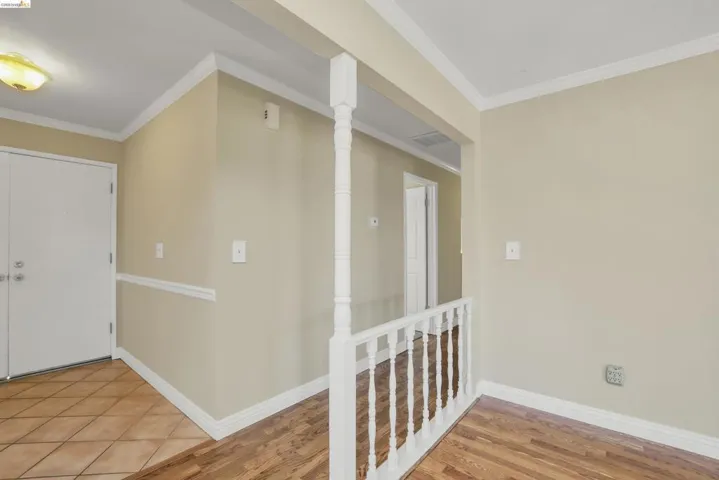 Entryway featuring terracotta-style tile flooring, a double-door entry, and a ceiling-mounted light fixture