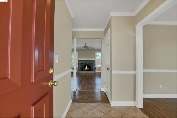 Entryway featuring a paneled front door, ceramic tile flooring, and crisp white trim
