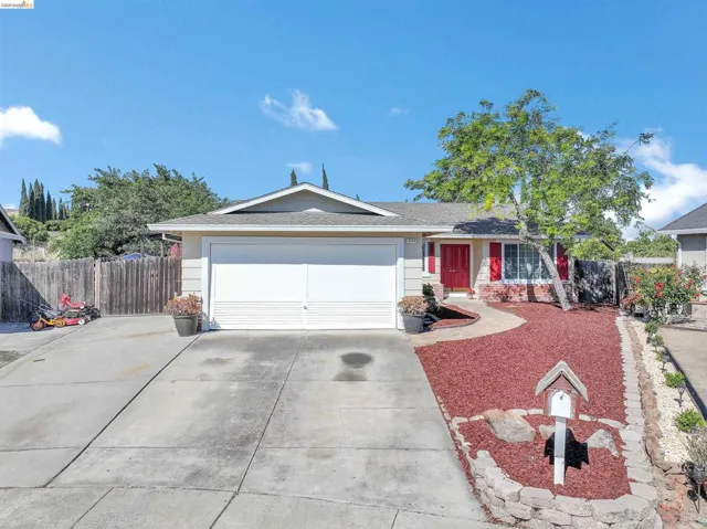 Single-story residence featuring a two-car garage, red front door, and complementary red shutters