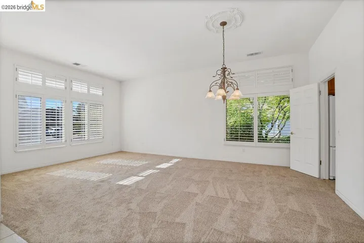 Spacious interior featuring neutral carpeting and white walls