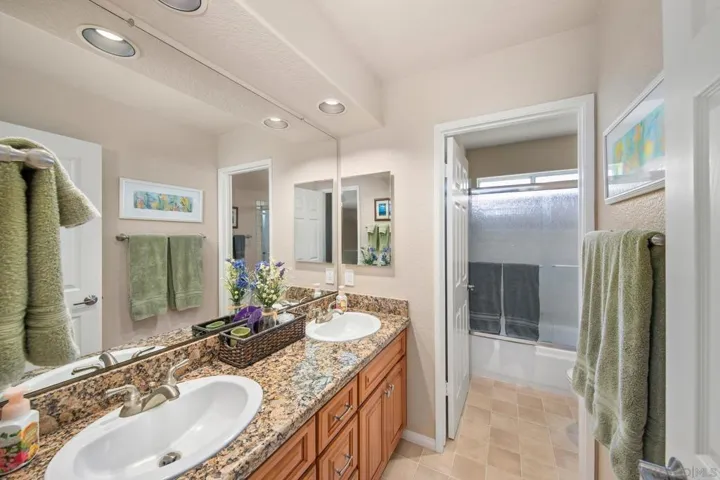 Upstairs hall bath with two sinks and a tub/shower combo
