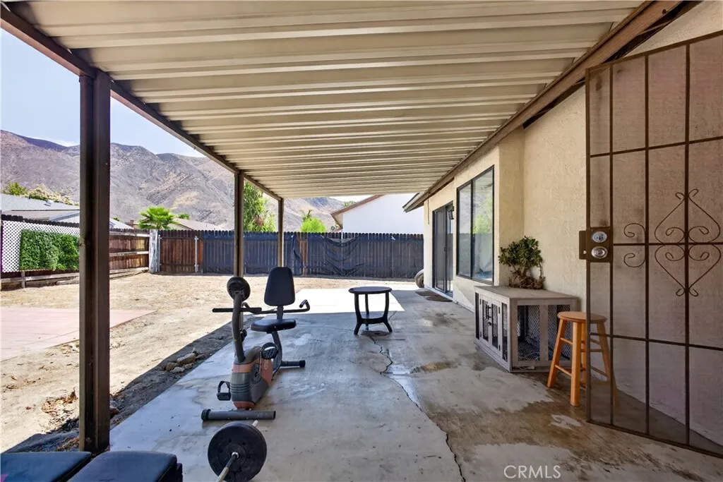 Covered patio with spacious backyard.