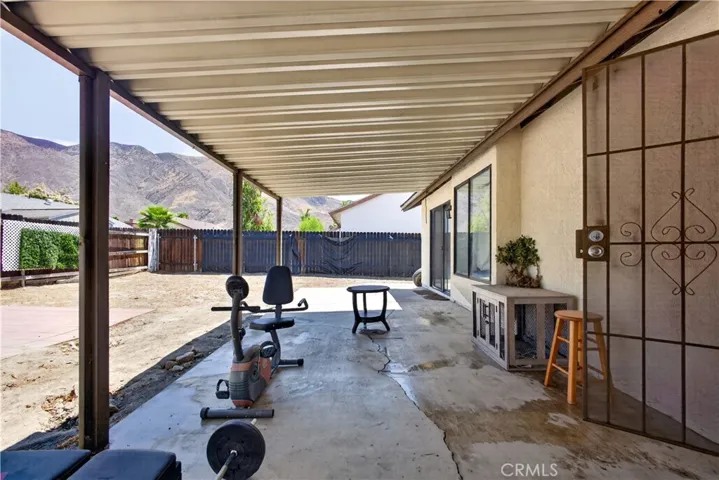 Covered patio with spacious backyard.