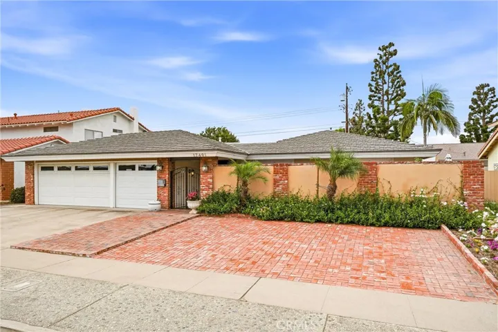 Front of single story home with 3 car garage and rod iron gated entry