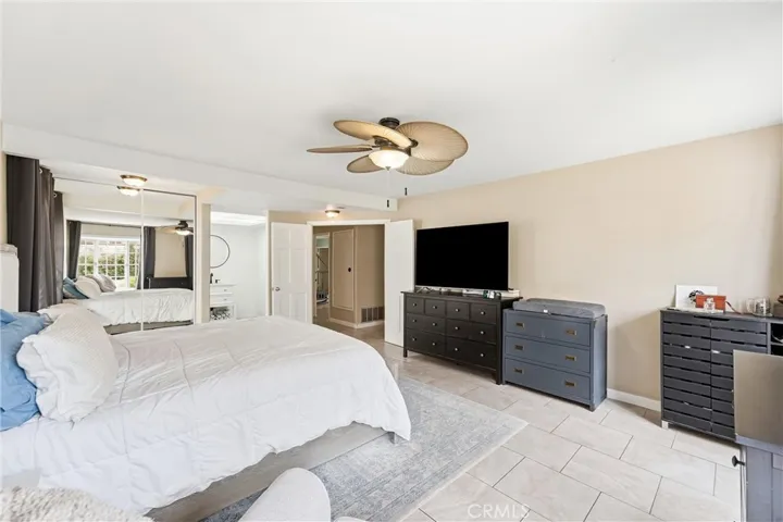 another view of bedroom with ceiling fan