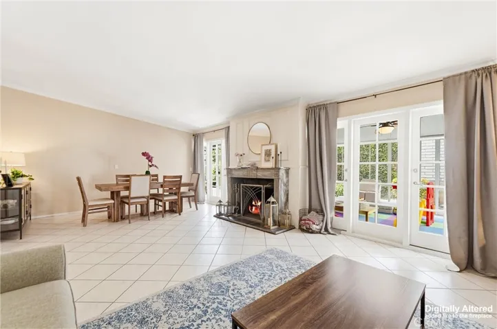 view of room wiht living room area and dining room that share marble fireplace