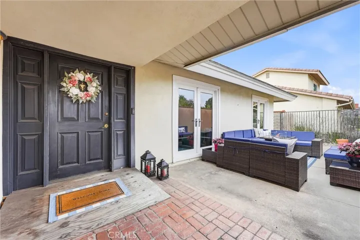 Covered porch with large courtyard to the right of door entry