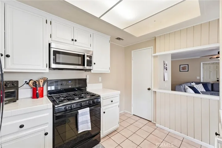 stainless steel and black appliances with tile counters