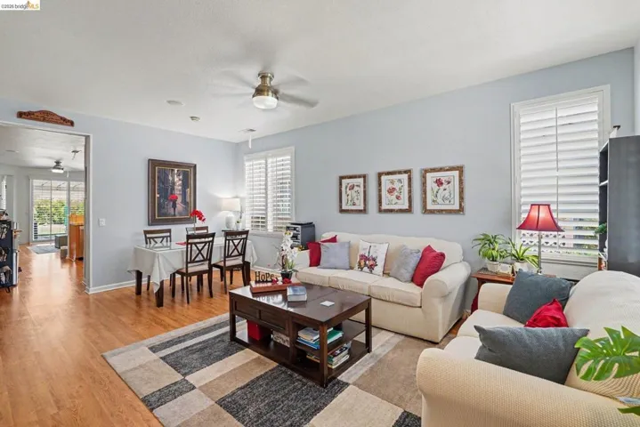 Combined living and dining area featuring wood-finish flooring