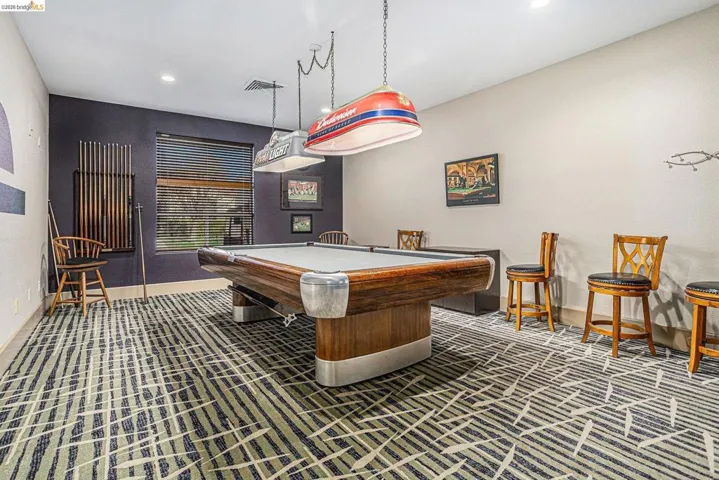 Recreation room featuring a classic billiards table, patterned carpet flooring, recessed lighting, and a window with horizontal blinds
