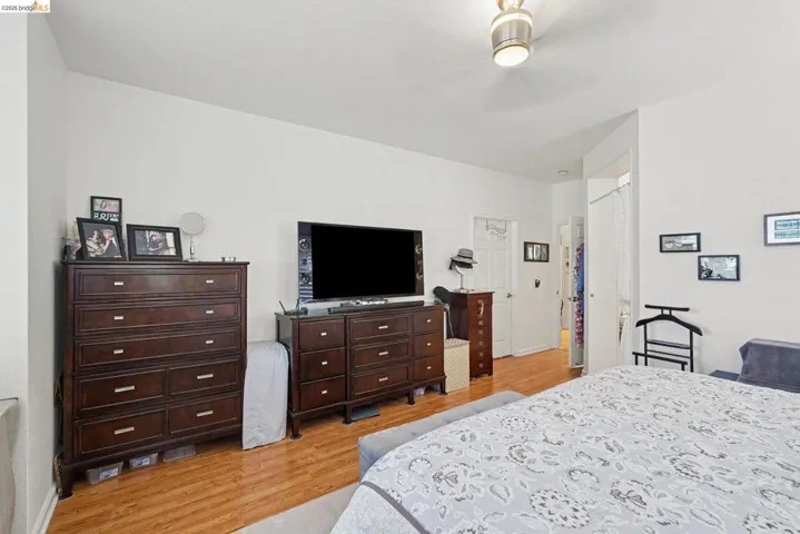 Interior room featuring light wood-finish flooring and a white ceiling with a flush-mount light fixture