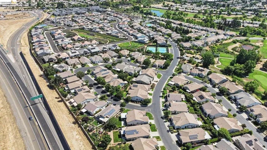 Aerial depiction of a residential community featuring single-story homes with individual yards