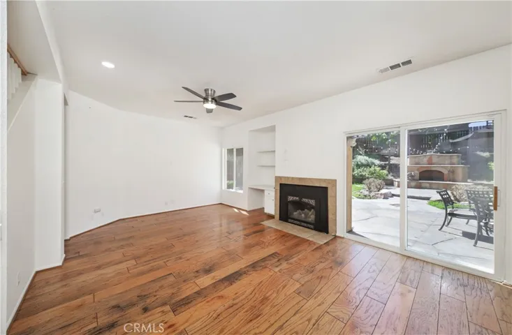 WOOD FLOORS DOWNSTAIRS.....BLINDS added to window left of fireplace, slider now had curtains