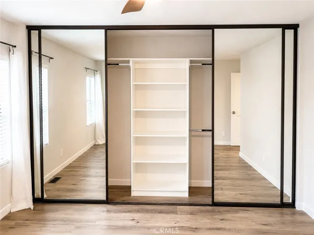 Primary Closet with mirrored closet doors