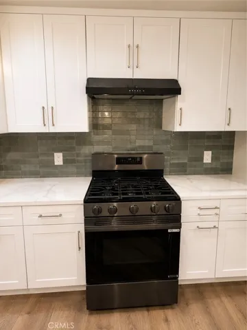 Gas stove and exhaust hood vented through roof