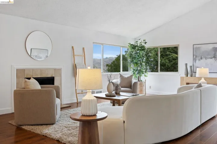 Vaulted ceilings complement the living area featuring wood-finish flooring