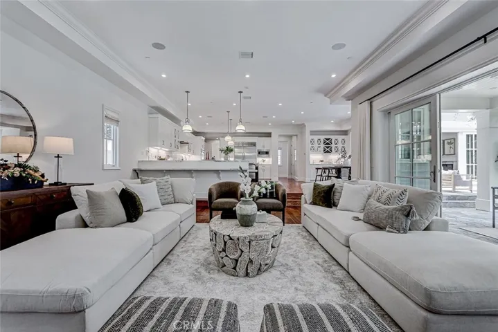 Family Room with View to Kitchen Area and French Door Access to Backyard Patio