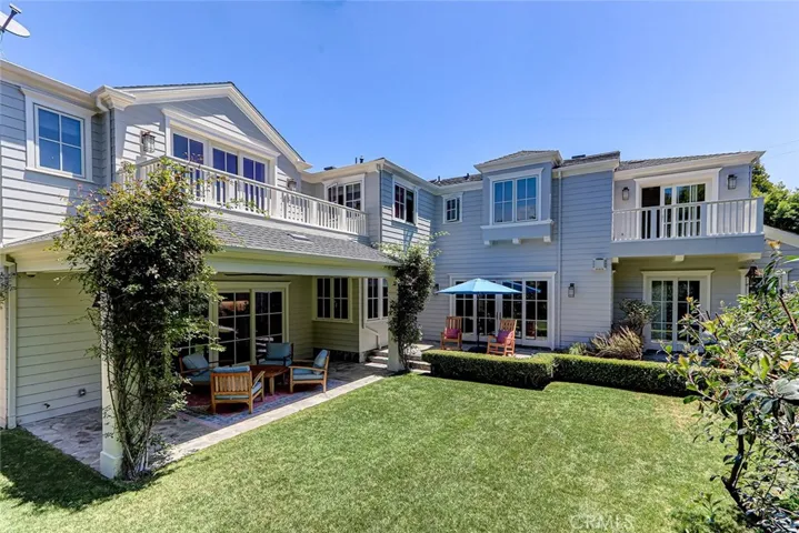 Backyard Area with View to Main Floor Patio Areas and 2nd Floor Decks