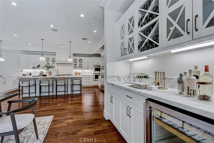 Wet Bar Area with Calacatta Marble Countertop and Built-In Beverage Refrigerator