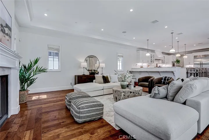 Family Room Area with Limestone Fireplace and View to Kitchen Area