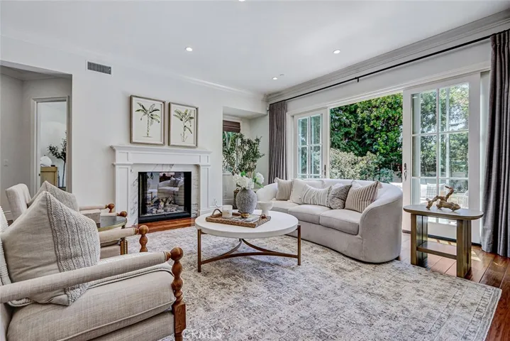 Formal Living Room Area with Marble Fireplace and French Door Access to Backyard Patio