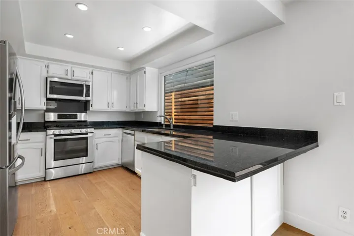 Kitchen has stainless steel appliances, dishwasher, granite countertops, and abundant cabinets & storage.