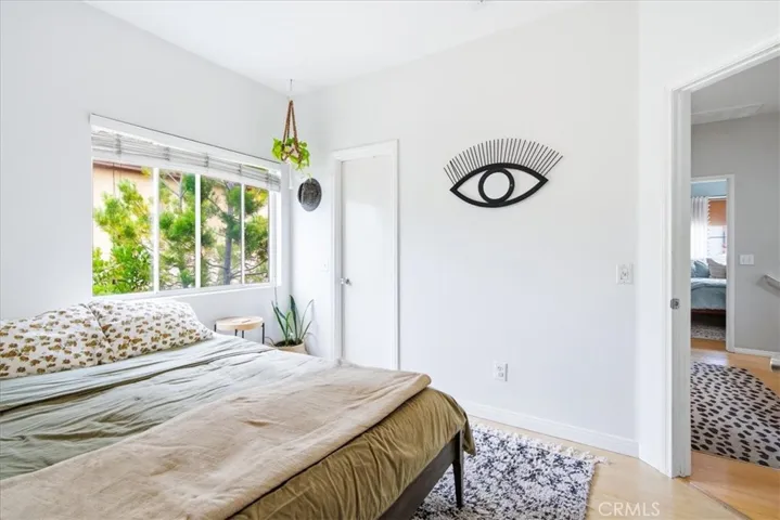Bedroom with large window and greenery views