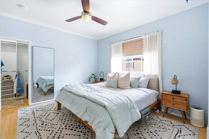 Bright bedroom with ceiling fan and natural light
