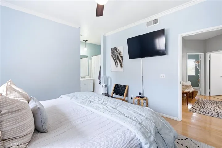 Primary bedroom featuring spacious layout and TV wall
