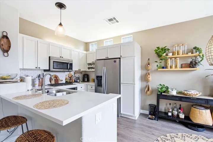 Kitchen island and prep area with open flow to living space
