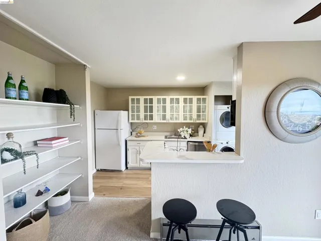 Kitchen featuring white cabinetry, light countertops, and wood-finish flooring