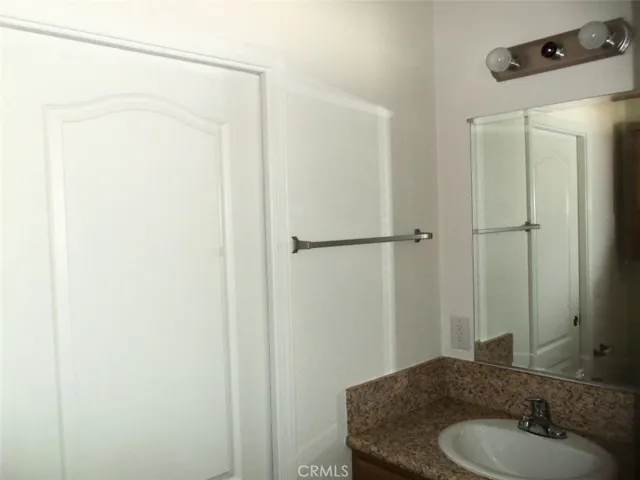 Main bath with sink and space saving pocket door