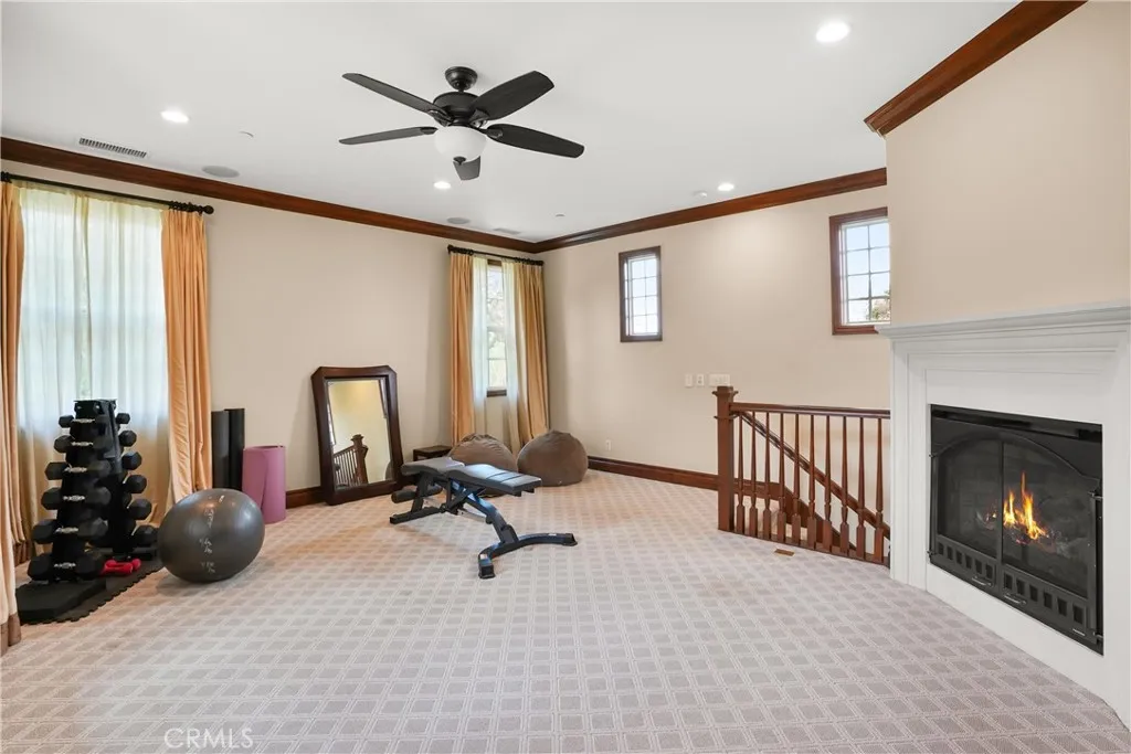 Expansive upstairs loft with fireplace. Ideal as a media room, game room, home office, fitness area, or additional living space.