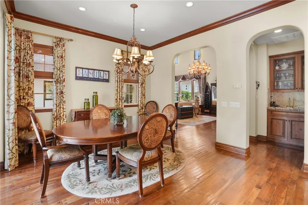 Elegant formal dining room with rich hardwood flooring and seamless access to the main living areas.
