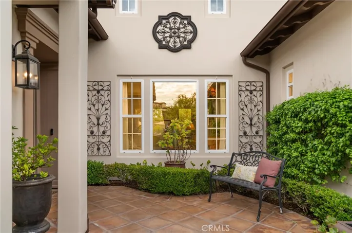 Private gated courtyard with decorative ironwork, and a welcoming outdoor sitting area.