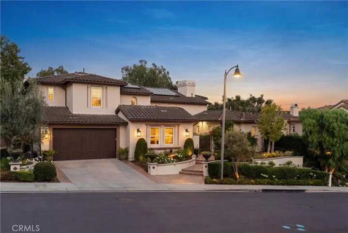Stunning curb appeal showcasing timeless architecture, manicured landscaping, and an inviting gated courtyard entry.