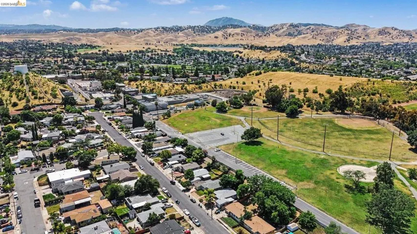 Expansive residential neighborhood featuring a mix of mature trees, paved streets, and single-story properties