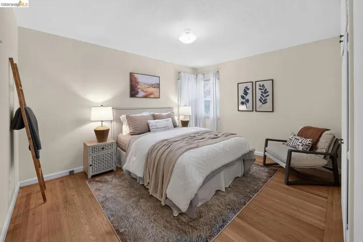 Bedroom featuring hardwood flooring and light-toned walls