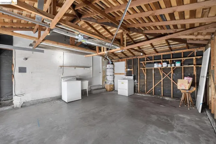 Exposed timber ceiling beams with concrete flooring