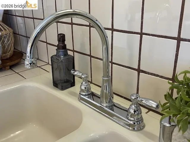 Cream-colored dual-basin sink with a chrome gooseneck faucet
